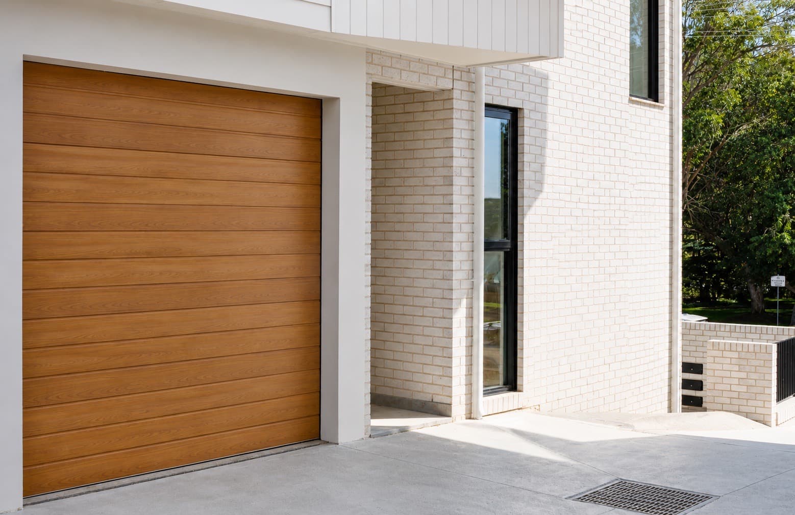 Private garage entry and white brick facade