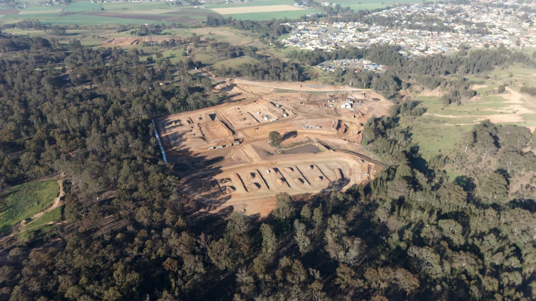 Wide aerial view of civil construction works underway across Langham Estate